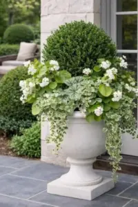 Large decorative planter with seasonal flowers and greenery enhancing a home's front entrance.